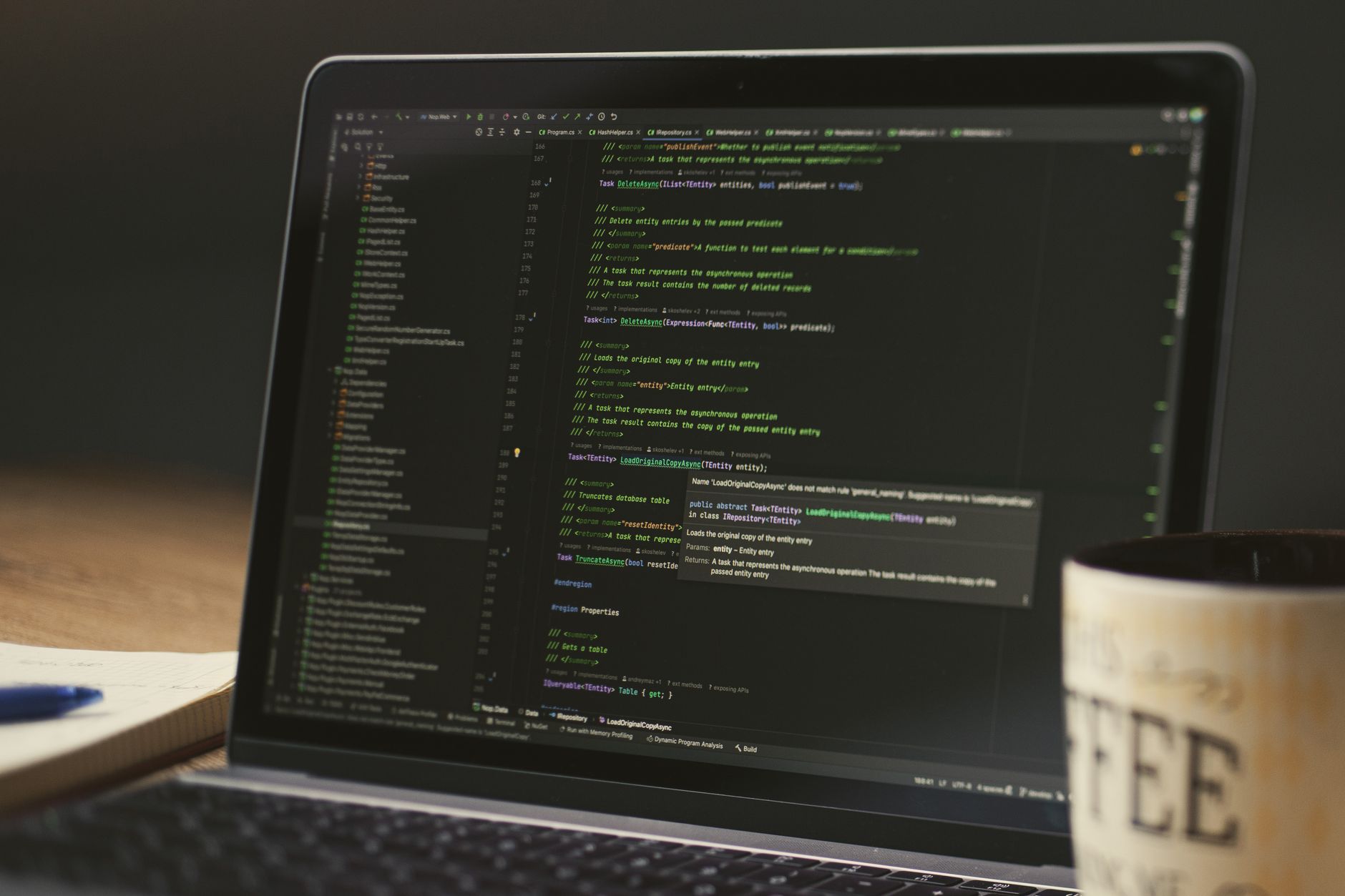 A laptop showing a dark code editor, late-night coding session